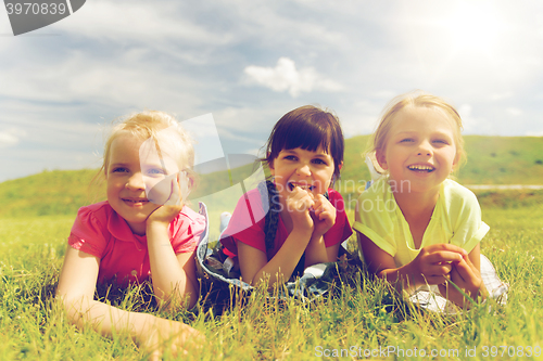 Image of group of kids lying on blanket or cover outdoors