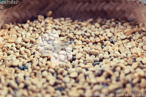 Image of close up of unroasted coffee beans in basket