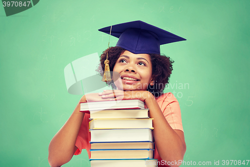 Image of happy african bachelor girl with books at school