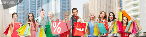 Image of happy people with sale sign showing thumbs up