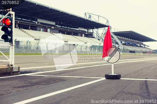 Image of red traffic lights and road sign on race track