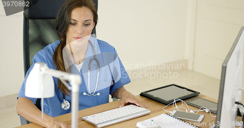 Image of Doctor working at her desk in the office