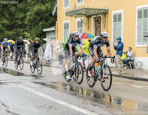 Image of Group of Cyclists Riding in the Rain - Tour de France 2014