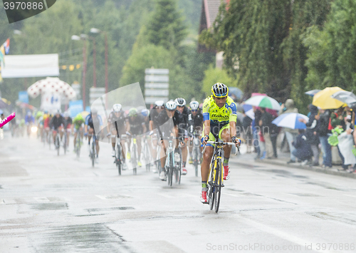 Image of The Peloton Riding in the Rain - Tour de France 2014