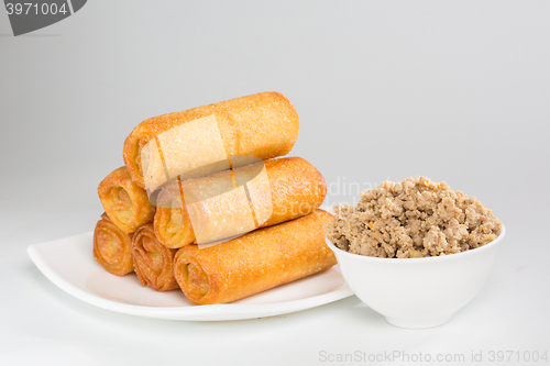 Image of pancakes with meat on white plate