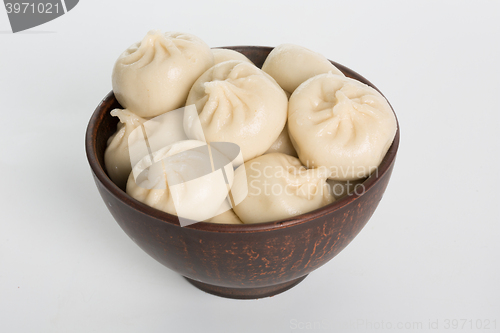 Image of khinkali cooked on a ceramic plate