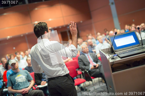 Image of Public speaker giving talk at Business Event.