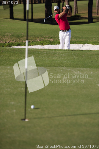 Image of golfer hitting a sand bunker shot