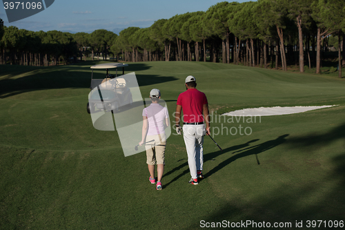 Image of couple walking on golf course
