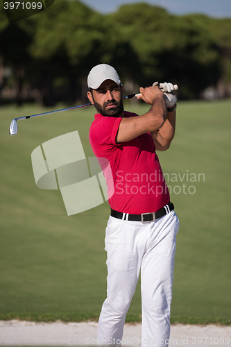 Image of golfer hitting a sand bunker shot