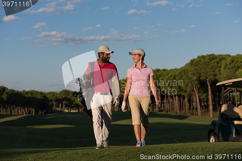 Image of couple walking on golf course