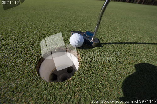 Image of hitting golf ball to hole