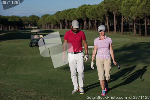 Image of couple walking on golf course