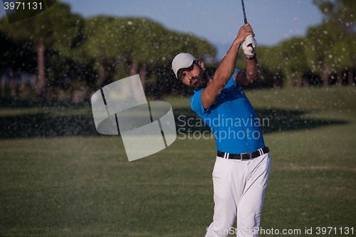 Image of pro golfer hitting a sand bunker shot