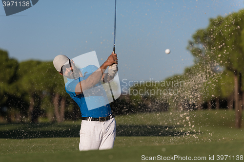 Image of pro golfer hitting a sand bunker shot