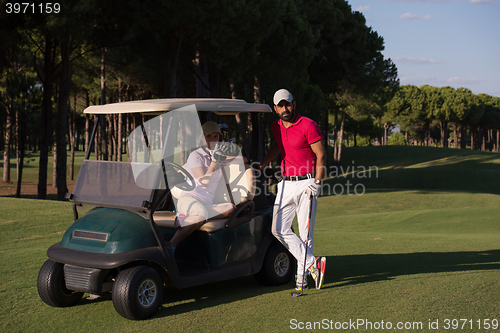 Image of couple in buggy on golf course