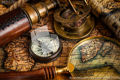 Image of Old vintage compass and travel instruments on ancient map