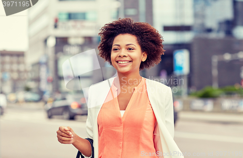Image of happy young african american businesswoman in city