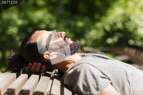 Image of happy man with earphones listening to music
