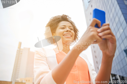 Image of happy african businesswoman with smartphone
