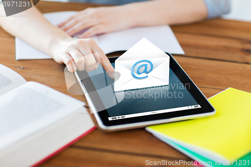 Image of close up of student with tablet pc and notebook