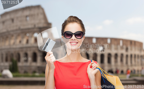 Image of woman with shopping bags and credit card in rome