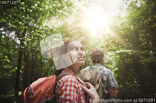 Image of group of smiling friends with backpacks hiking