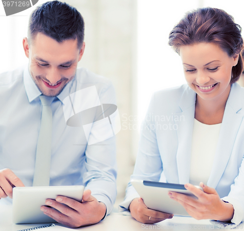 Image of business team working with tablet pcs in office