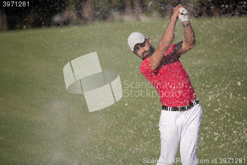 Image of golfer hitting a sand bunker shot