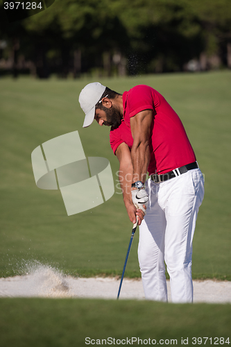 Image of golfer hitting a sand bunker shot