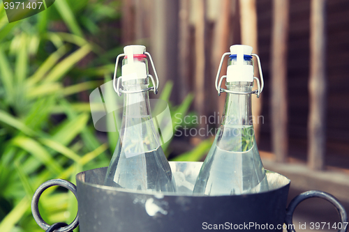 Image of couple of water bottles in ice bucket at hotel