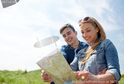 Image of happy couple with map outdoors