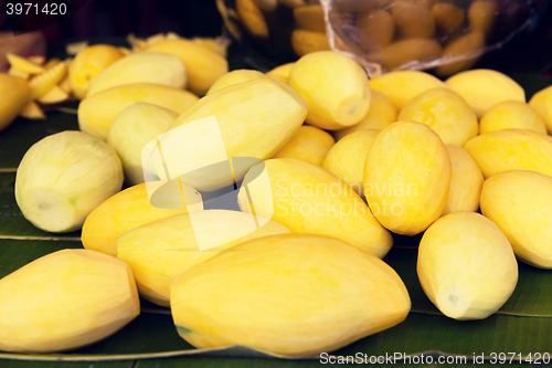 Image of peeled mango at street market