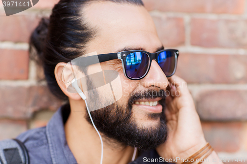 Image of happy man with earphones listening to music