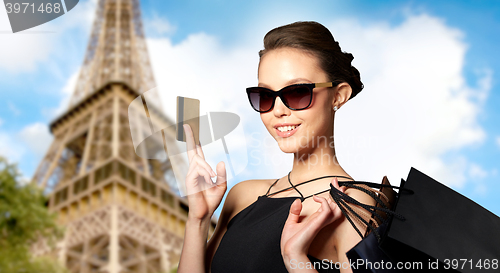 Image of happy woman with credit card and shopping bags