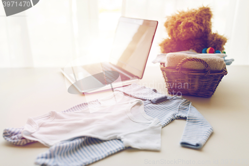 Image of close up of baby clothes and toys for newborn