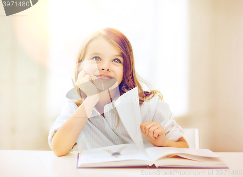 Image of little student girl studying at school