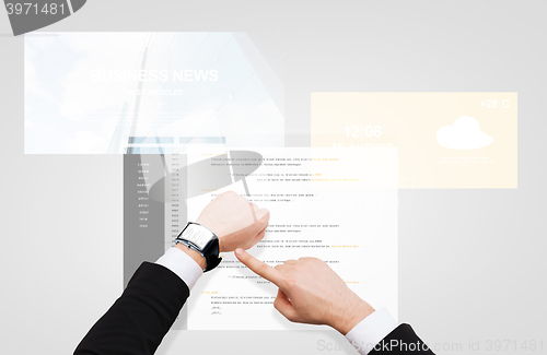 Image of businessman hands with coding on smart watch