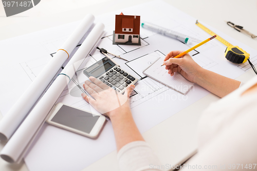 Image of close up of architect hand counting on calculator