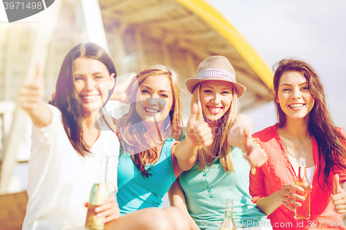 Image of girls with drinks on the beach