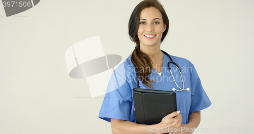 Image of Smiling young female physician smiles at camera