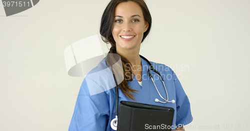 Image of Smiling young female physician smiles at camera