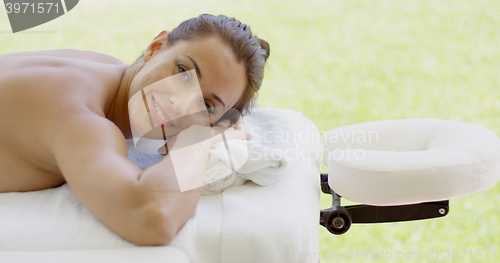 Image of Woman smiles at camera while at spa