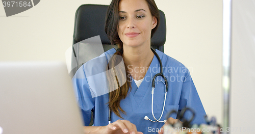 Image of Beautiful female doctor at laptop computer