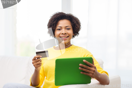 Image of happy african woman with tablet pc and credit card