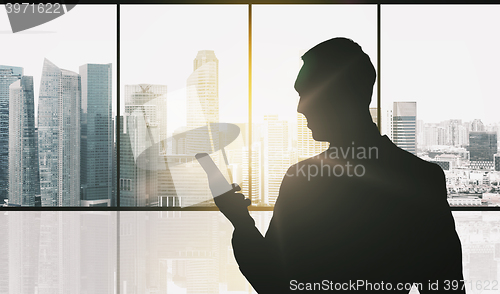Image of silhouette of businessman with smartphone
