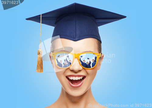 Image of happy teenage girl in shades and mortarboard hat