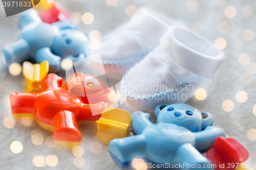 Image of close up of baby rattle and bootees for newborn