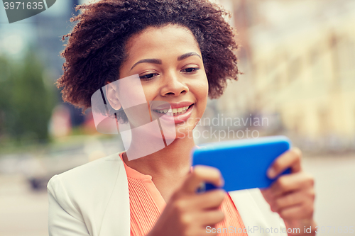 Image of happy african businesswoman with smartphone