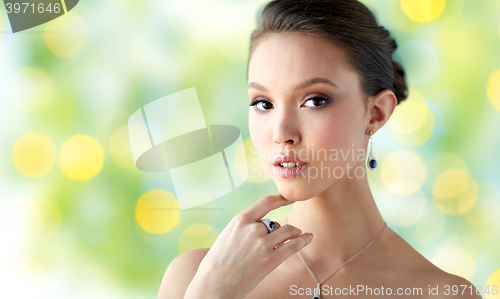 Image of beautiful woman with earring, ring and pendant